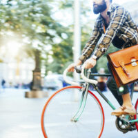 Young hipster man speeding with his bike.